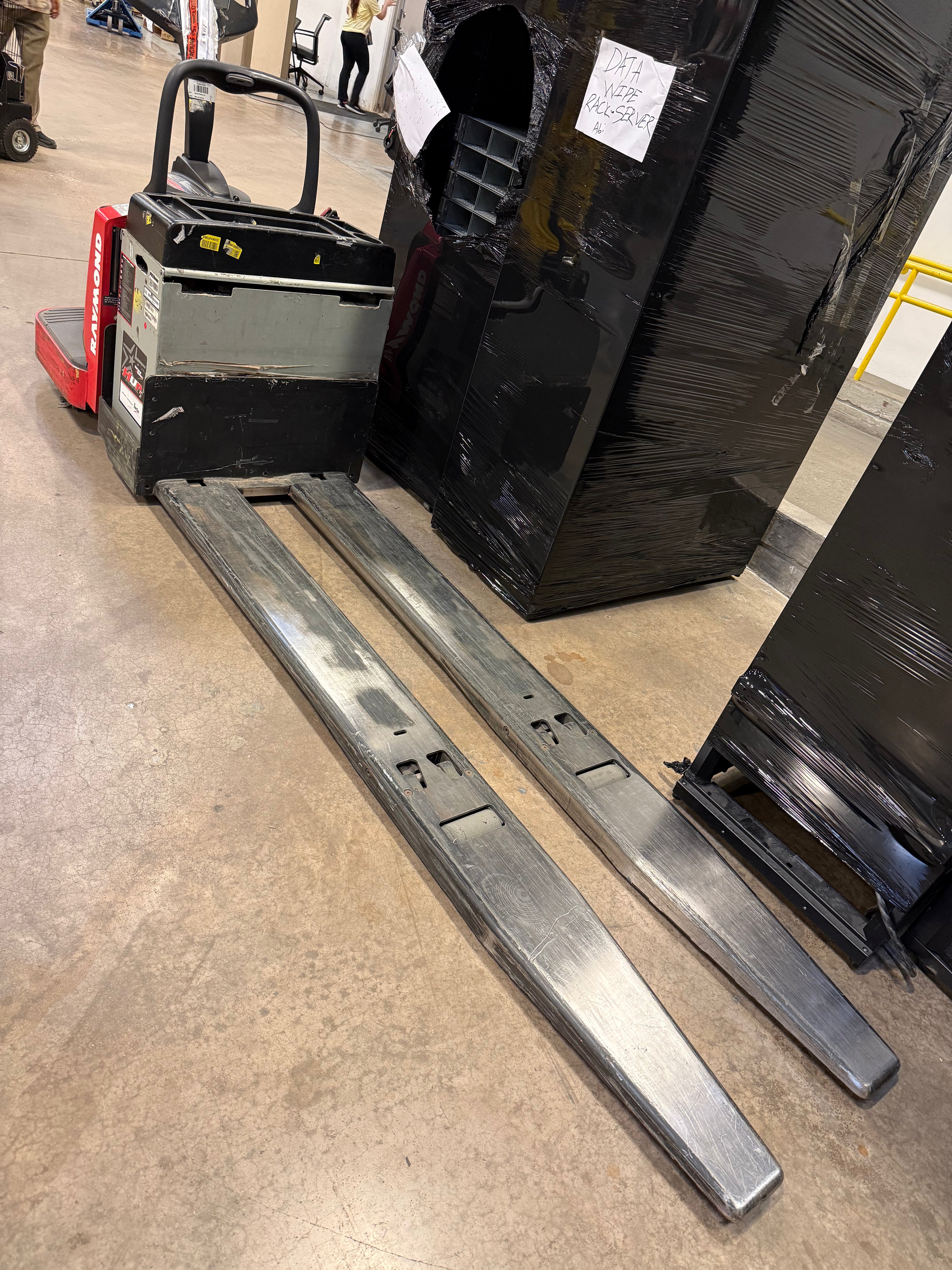 Raymond 8410 electric pallet jack – front view showing forks